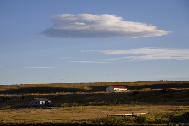 AKG1529320.webp Paysage Rural avec Bâtiments Sous un Ciel Nuageux – Image 1