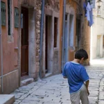 Enfant dans une ruelle européenne pavée