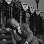 Homme endormi sur un banc près de jumelles panoramiques