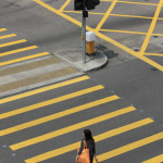 Passante traversant un passage piéton occupé.