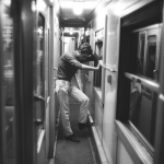 Homme pensif dans le couloir d'un train en noir et blanc