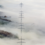 Pylônes électriques émergeant de la brume dense