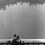 Couple assis au bord de l'eau