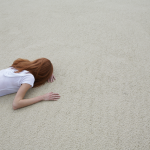 Femme allongée sur le sable