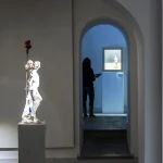 Visiteur dans une galerie d'art avec statues en exposition