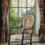 Fauteuil ancien devant une fenêtre avec rideaux rouges dans une pièce décorée