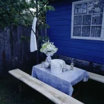 Table de jardin avec nappe bleue et seau blanc
