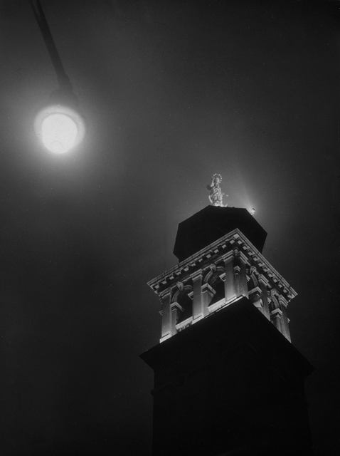 AKG4559184.webp Statue illuminée sur une tour au clair de lune – Image 1