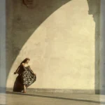 Femme dansante sous une arcade ensoleillée