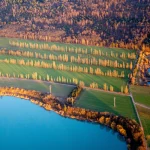Vue aérienne de champs avec lacs et forêt en arrière-plan