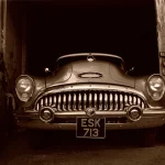 Voiture ancienne garée dans un garage abandonné