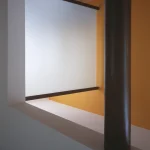 Architecture intérieure moderne avec colonne noire et mur orange