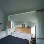 Chambre contemporaine avec lit en bois et chevet personnel