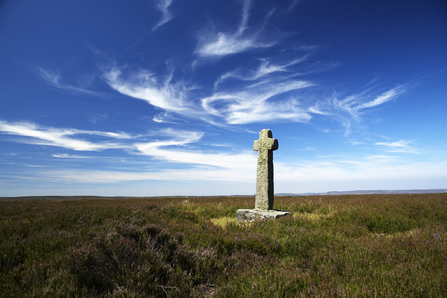 AKG5396007.webp Croix en pierre dans une lande sous un ciel bleu – Image 1