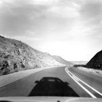 Vue d'une route de montagne avec l'ombre d'une voiture