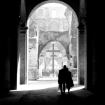 Couple marchant à travers une arche ancienne dans un site historique