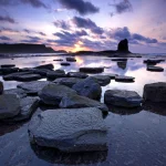 Coucher de soleil sur une plage rocheuse