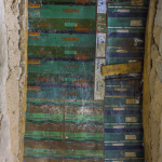 Vielle porte en métal et bois dans un mur en pierre