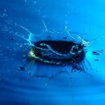 Goutte d'eau créant une éclaboussure sur une surface bleue