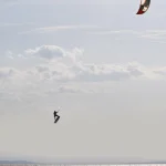 Kitesurfeur au-dessus de l'océan sous un ciel nuageux