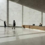 Hall d'entrée spacieux avec réception et jeu d'ombres.