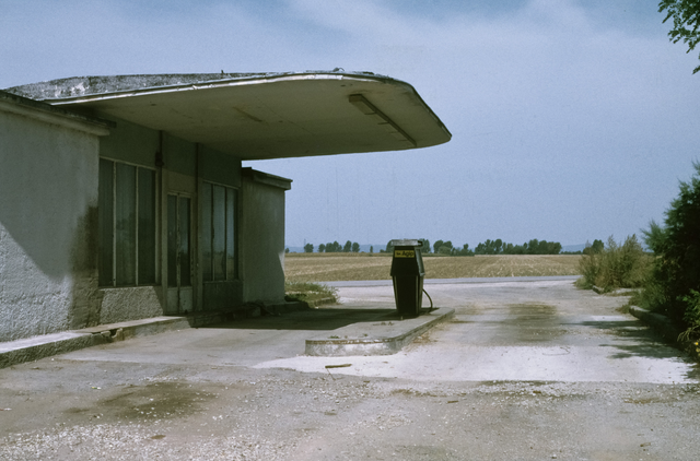 AKG8593231.webp Station-service abandonnée sur une route campagne – Image 1