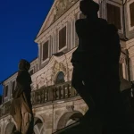 Statues devant un bâtiment historique la nuit