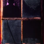 Silhouette derrière une fenêtre sombre