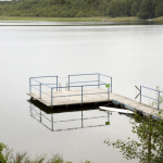 Jetée sur un lac avec forêt en arrière-plan