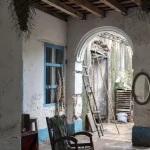 Patio intérieur d'une maison en ruine avec des meubles en bois