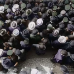 Crowd wearing hats seen from above
