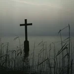 Croix au bord du lac par temps brumeux